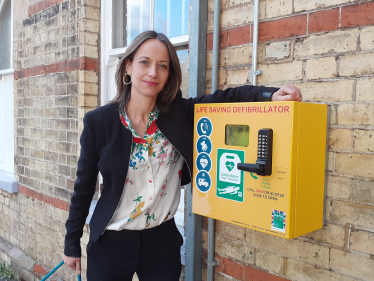 Helen with a newly installed defibrillator at Bearsted station